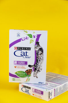 Two white boxes of cat food against a yellow background. Purina Cat Chow. Purina is an American subsidiary of Nestlé, based in St. Louis, Missouri. Ukraine, Mykolayiv - 05 25 2022