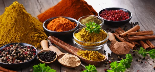 Foto auf Glas Variety of spices on kitchen table © monticellllo
