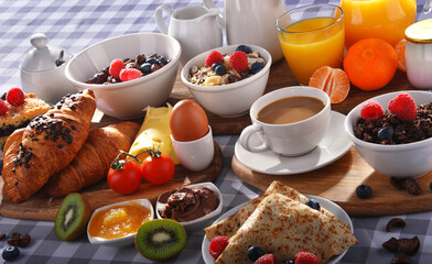 Breakfast served with coffee, juice, croissants and fruits