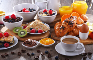 Breakfast served with coffee, juice, croissants and fruits