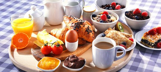 Breakfast served with coffee, juice, croissants and fruits