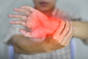Inflammation of Asian man wrist joint. Concept of joint pain and hand problems.