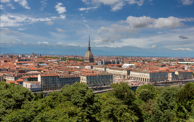 Obraz premium Turin, Piedmont, Italy - cityscape seen from above with piazza Vittorio and the Mole Antonelliana architecture symbol of the city of Turin, in the background the Alps with blue sky with clouds