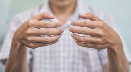 Hand of Asian young man. Concept of rheumatoid arthritis, osteoarthritis, or joint pain