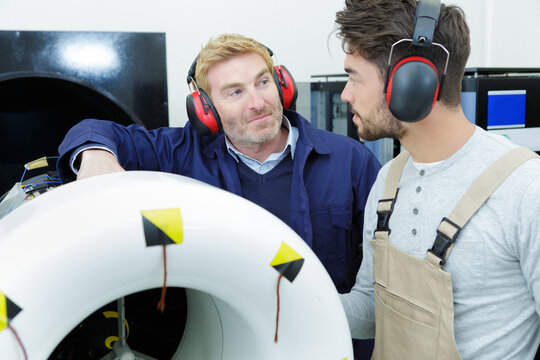 a foreman teaching apprentice engineer