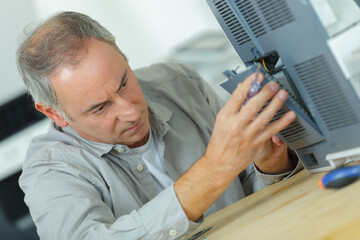 a technician fixing a printer