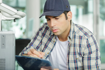 man checking a printing machine