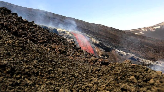 Etna volcano-Lava flow movement detail on Etna volcano erupting during 7june 2022
