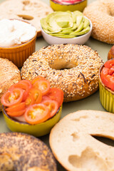 lot of different bagels with stuffing laid out on the table