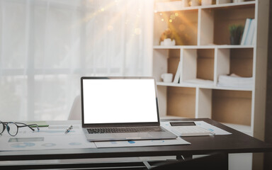 Laptop or notebook with blank screen on business desk for display your ads.