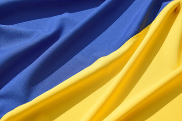 Fabric bent national flag of Ukraine, UA.