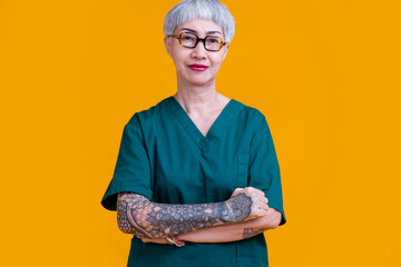 old senior asian female professional doctor grey hair and tattoo with glasses wear hospital uniform...