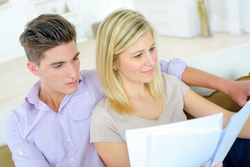 a couple is reading paperwork