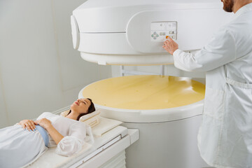 Woman patient is ready to do magnetic resonance imaging MRI or CT scan in clinic