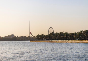 Sharjah, UAE - 02.06.2021 - UAE national flag half lowered at Noor island area. Outdoors