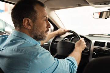 Male Driver Driving Sitting In Automobile, Back View