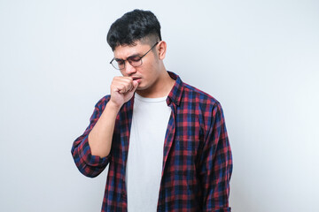 Young asian man wearing casual shirt and glasses coughing with sore throat, concept of man with...
