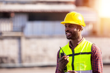 African American worker working in containers control station shipment import export
