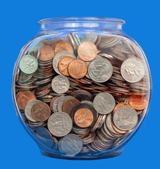 Fish bowl filled with United States coins on a blue background.