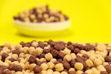 Corn balls with cocoa on a yellow background. Quick cereal healthy breakfasts for children and adults.