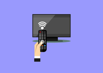 Hand holding wireless remote control near flat screen tv.