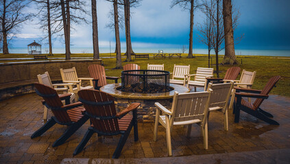 Geneva-On-The-Lake, Ohio, USA - 4-8-22:  A patio with a fire pit and lawn chairs at the Geneva Lodge