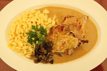 spaetzle with a gratinated escalope and parsley