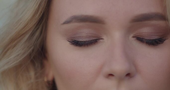 Beautiful woman&rsquo;s eyes opening while looking at camera. Gorgeous woman with long eyelashes and attractive appearance