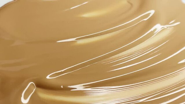 Glossy cosmetic texture, beige liquid foundation or concealer as beauty make-up product background, skincare cosmetics and luxury makeup brand design concept