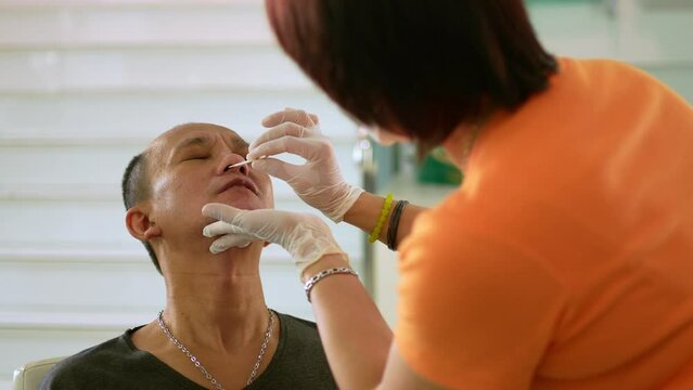 Asian man worker medical swab test covid before working in a factory. Concept of prevent respiratory epidemic and weekly swab test