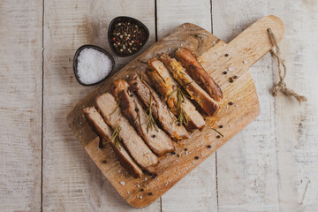 Roasted pork, slices pork meat on cutting board piece 
