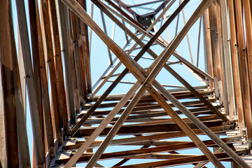 Close-up view of an electric tower with a beautiful blue sky background. Industrial engineering concept. Iron structure for high-voltage electrical engineering.