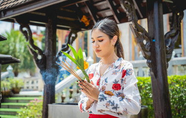 Beautiful Asian girl at big Buddhist temple dressed in traditional costume