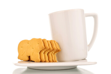 Several zoological cookies with a white cup on a saucer, macro, isolated on a white background.