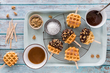 Dipped waffle pops with one on the side ready for decorating.