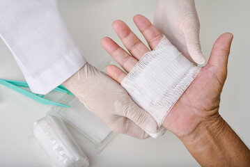 Doctor doing wound dressing care and bandaging patient's hand, Hand surgery treatment, Nurse treat...