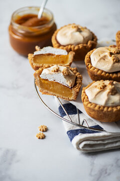 Lemon curd tartlets with whipped meringue and caramel sauce.