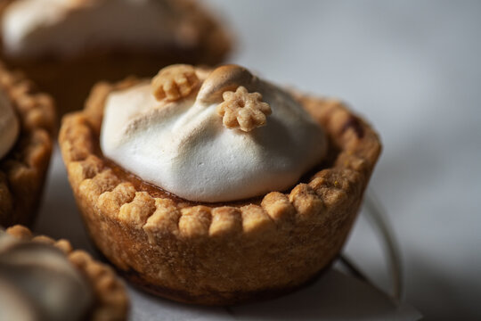 Lemon curd tartlets with whipped meringue. Close up.