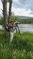 Photographer taking pictures in the rain at Aqua-Terra Park in Upstate NY.