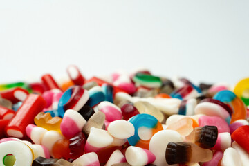 Tasty mix of jelly colorful candies isolated on a white background.