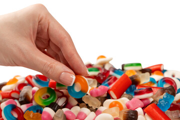 Woman hand takes a jelly candy on white background.