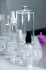 Cosmetic empty bottles and containers. Organizers for cotton swabs and disks. Beauty saloon.