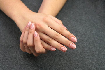 Women's hands after manicure and gel polish. Cosmetology procedure and skin care in a beauty salon.