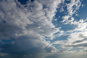 Clouds on the blue sky in sunlight.