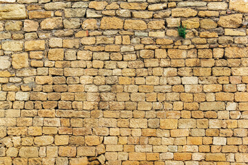 background, texture - a wall of rough blocks, with cracks between stones