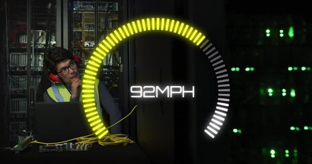 Animation of speedometer over biracial man using laptop in server room - Powered by Adobe