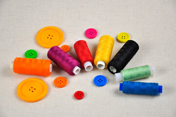 Colourful buttons and multicolored threads for sewing clothes.