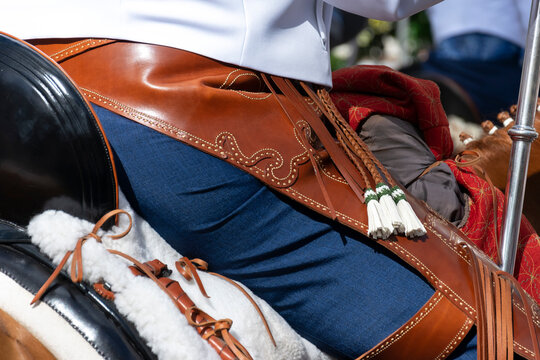 Detail of the chaps of a horseman in the traditional outing of the brotherhood of Roc&iacute;o de Huelva in Spain