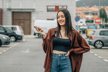 Obraz premium young girl on the street with mobile phone