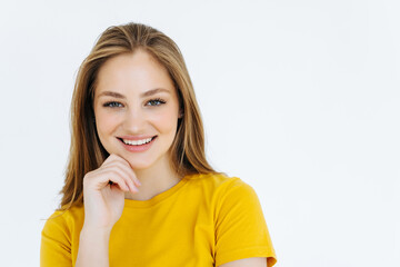 Fototapeta premium Beautiful young student in red trendy sweater smiling and holding her hand on chin, isolated over white background.